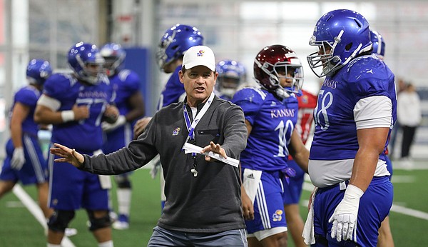 Kansas head coach Les Miles works with offensive lineman Api Mane on Thursday, April 4, 2019 at the indoor practice facility.
