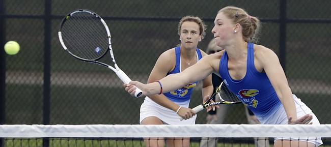 Kansas No. 1 doubles players Janet Koch, left, watches her teammate, Nina Khmelnitckaia, return a volley at the net during their NCAA Tournament doubles match against Denver on Friday, May 3, 2019, at Jayhawk Tennis Center at Rock Chalk Park. The Jayhawks defeated Denver 4-0 to advance to play Florida in Round 2.