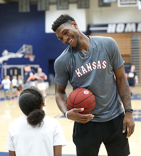 Kansas forward Silvio De Sousa (22) jokes with a camper during a Washburn University basketball camp on Tuesday, June 4, 2019 at Lee Arena in Topeka.