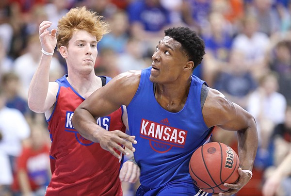 Kansas forward David McCormack drives to the bucket against Kansas guard Chris Teahan during a scrimmage on Tuesday, June 11, 2019 at Allen Fieldhouse.