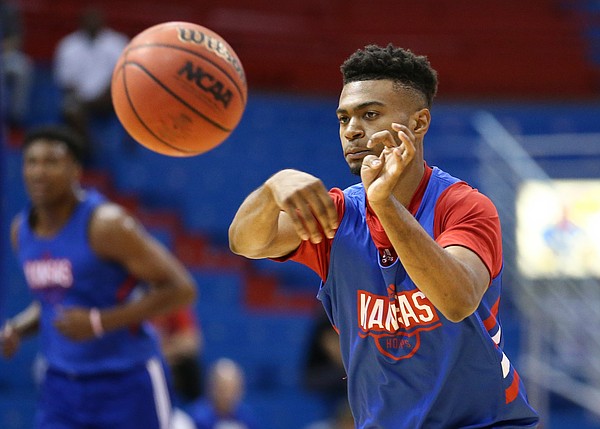 Kansas newcomer Isaac McBride throws a pass during a scrimmage on Tuesday, June 11, 2019 at Allen Fieldhouse.