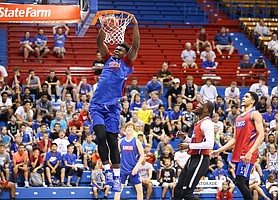 Kansas center Udoka Azubuike comes in for a dunk past former Kansas guard Tyshawn Taylor and current forward Tristan Enaruna during a scrimmage on Tuesday, June 18, 2019 at Allen Fieldhouse.