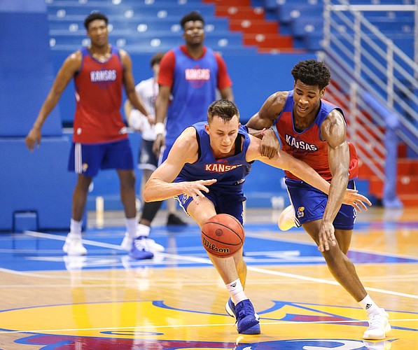Kansas forward Mitch Lightfoot and Kansas guard Ochai Agbaji compete for a ball during a scrimmage on Tuesday, June 18, 2019 at Allen Fieldhouse.
