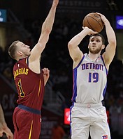 Detroit Pistons' Sviatoslav Mykhailiuk (19), from Ukraine, shoots against Cleveland Cavaliers' Nik Stauskas (1) in the first half of an NBA basketball game, Saturday, March 2, 2019, in Cleveland. (AP Photo/Tony Dejak)
