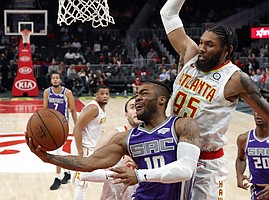 FILE — Sacramento Kings guard Frank Mason III (10) goes in for a basket as Atlanta Hawks forward DeAndre' Bembry (95) defends during the second half of an NBA basketball game Thursday, Nov. 1, 2018, in Atlanta. The Kings waived Mason on July 4, 2019, making him a free agent. (AP Photo/John Bazemore)