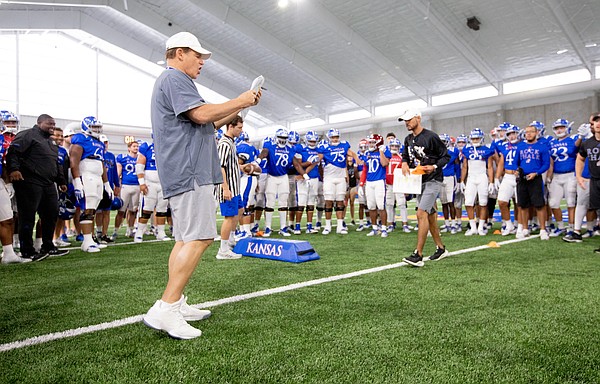 Kansas head coach Les Miles calls out players to go head-to-head in the Jayhawk drill during practice on Thursday, Aug. 8, 2019.
