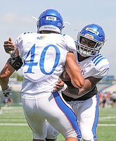 Kansas linebacker Kyron Johnson works on technique with fellow position player Dru Prox during practice on Friday, Aug. 9, 2019.