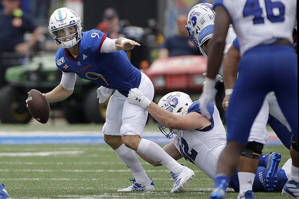Kansas quarterback Carter Stanley (9) is sacked by Indiana State defensive lineman Henrik Barndt (92) during the second half of an NCAA college football game Saturday, Aug. 31, 2019, in Lawrence, Kan. Kansas won 24-17. (AP Photo/Charlie Riedel)
