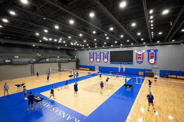 The Kansas volleyball team practices on a new Taraflex floor featuring the Jayhawk logo at the new Horejsi Family Volleyball Arena on Wednesday, Sept. 11, 2019.