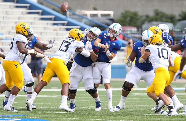 Kansas quarterback Carter Stanley (9) loses the ball as he is hit during the second quarter on Saturday, Sept. 21, 2019 at David Booth Kansas Memorial Stadium.