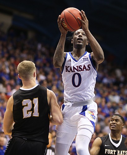 Kansas guard Marcus Garrett (0) floats in for a bucket over Fort Hays State forward Jared Vitztum (21) during the second half, Thursday, Oct. 24, 2019 at Allen Fieldhouse.