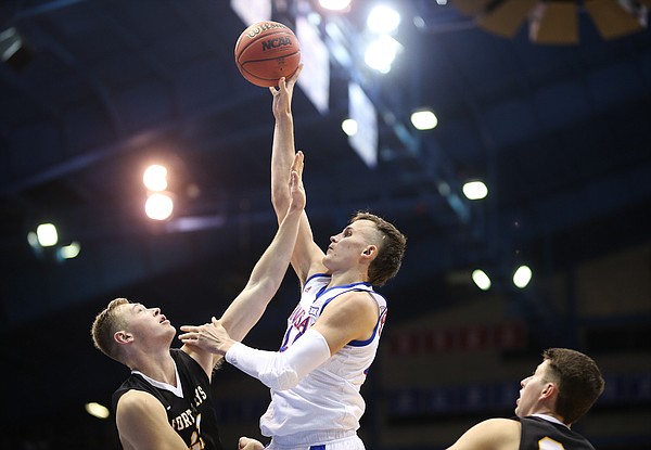 Kansas forward Mitch Lightfoot (44) turns for a bucket over Fort Hays State forward Jared Vitztum (21) during the second half, Thursday, Oct. 24, 2019 at Allen Fieldhouse.