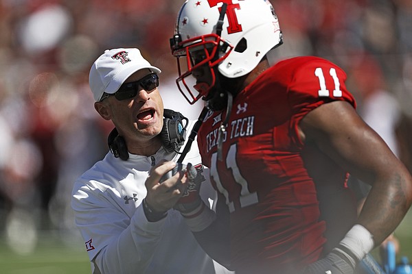 Texas Tech coach Matt Wells talks to Donta Thompson (11) during the second half of an NCAA college football game against Iowa State, Saturday, Oct. 19, 2019, in Lubbock, Texas. (Brad Tollefson/Lubbock Avalanche-Journal via AP)