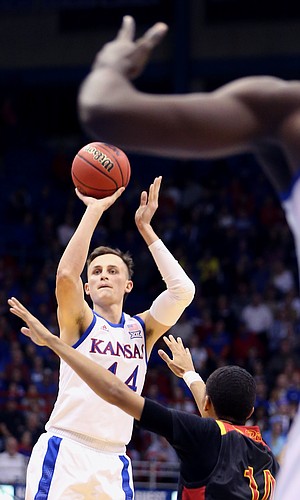 Kansas forward Mitch Lightfoot (44) launches a three-point shot during the second half of KU’s win against Pittsburg State Thursday at Allen Fieldhouse. 