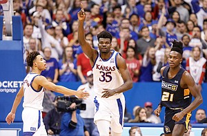Kansas center Udoka Azubuike (35) signals the ball going the Jayhawks' way as he and Kansas guard Devon Dotson (1) celebrate a UNC-Greensboro turnover during the second half, Friday, Nov. 8, 2019 at Allen Fieldhouse. At right is UNC-Greensboro forward James Dickey (21).
