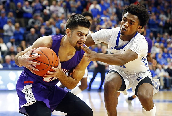 Evansville's Sam Cunliffe, left, is fouled by Kentucky's Ashton Hagans, right, late in the second half of an NCAA college basketball game in Lexington, Ky., Tuesday, Nov. 12, 2019. Cunliffe hit the two free throws. Evansville won 67-64. (AP Photo/James Crisp)

