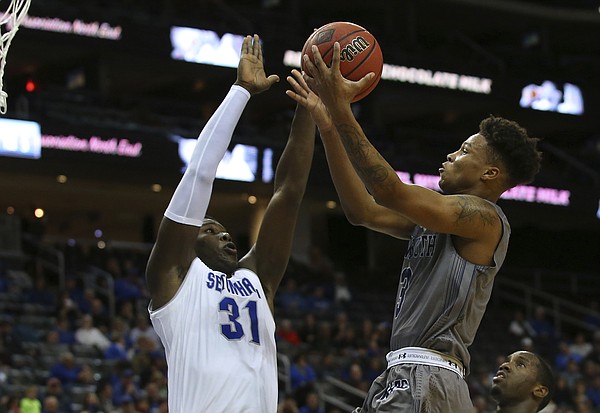 Monmouth's Deion Hammond, right, takes a shot as Seton Hall's Angel Delgado (31) defends during an NCAA college basketball game in Newark, N.J., Sunday, Nov. 12, 2017. Seton Hall defeated Monmouth 75-65. (AP Photo/Rich Schultz)