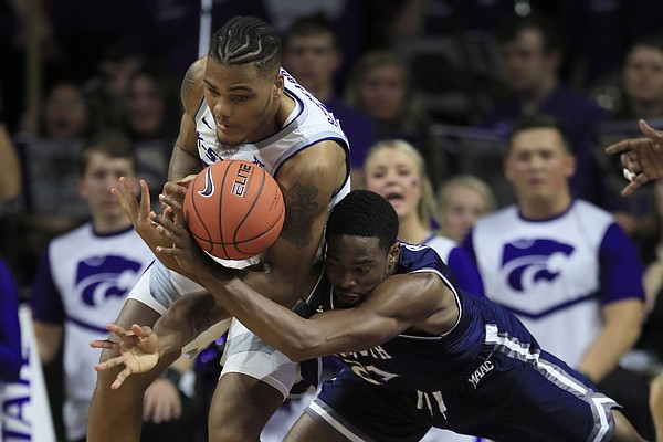 Monmouth forward Nikkei Rutty, right, battles Kansas State forward Levi Stockard III (34) for the ball during the first half of an NCAA college basketball game in Manhattan, Kan., Wednesday, Nov. 13, 2019. (AP Photo/Orlin Wagner)