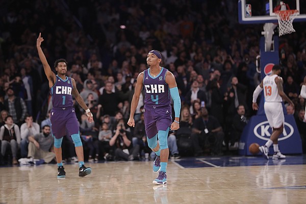 Charlotte Hornets' Devonte' Graham (4) and teammate Malik Monk (1) react after Graham hit the game winning 3-pointer during the second half of an NBA basketball game against the New York Knicks Saturday, Nov. 16, 2019, in New York. The Hornets won 103-102. (AP Photo/Frank Franklin II)
