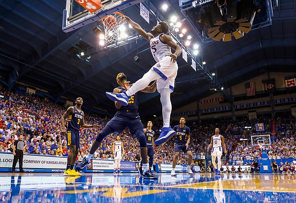 Kansas center Udoka Azubuike (35) powers in a dunk against East Tennessee State center Lucas N'Guessan (25) during the second half on Tuesday, Nov. 19, 2019 at Allen Fieldhouse.