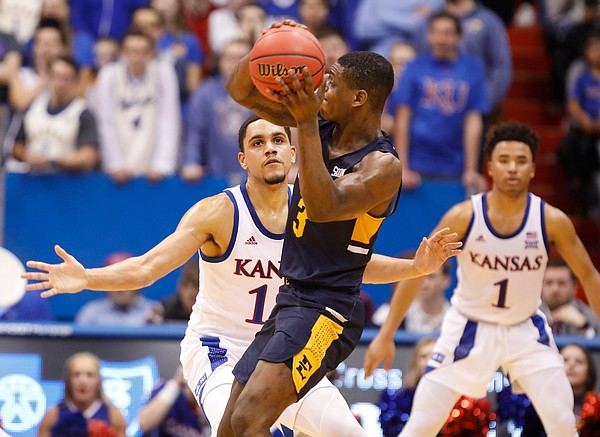 Kansas guard Tristan Enaruna defends against a pass from East Tennessee State guard Bo Hodges (3) during the second half on Tuesday, Nov. 19, 2019 at Allen Fieldhouse.