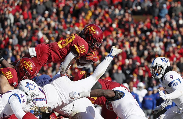 Iowa State running back Breece Hall, center, dives over the Kansas defensive line to score a touchdown during the first half of an NCAA college football game, Saturday, Nov. 23, 2019, in Ames, Iowa. (AP Photo/Matthew Putney)