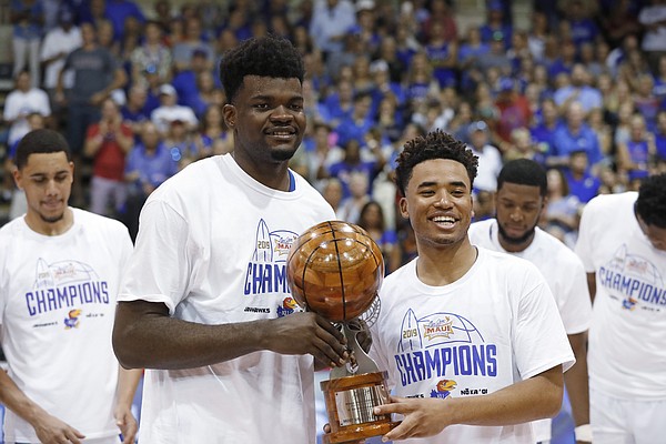 Kansas center Udoka Azubuike, left, and guard Devon Dotson share the Maui Invitational co-MVP trophy, Wednesday, Nov. 27, 2019, in Lahaina, Hawaii. Kansas defeated Dayton in 90-84 in overtime in an NCAA college basketball game for the tournament title. (AP Photo/Marco Garcia)