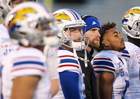 Kansas offensive coordinator Brent Dearmon watches a replay on the video board during the third quarter on Saturday, Nov. 30, 2019 at Memorial Stadium.