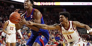 Kansas forward David McCormack drives to the basket ahead of Iowa State guard Prentiss Nixon, right, during the first half of an NCAA college basketball game Wednesday, Jan. 8, 2020, in Ames, Iowa. (AP Photo/Charlie Neibergall)