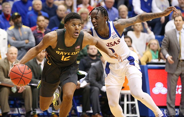 Baylor guard Jared Butler (12) gets around Kansas guard Marcus Garrett (0) as he heads to the bucket during the second half on Saturday, Jan. 11, 2020 at Allen Fieldhouse.