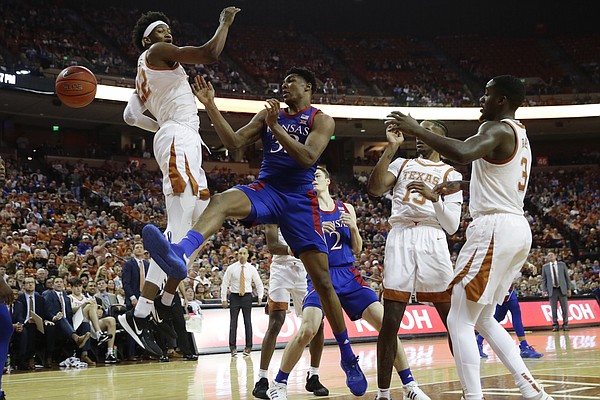 Kansas forward David McCormack (33) loses control of the ball as he tries to score past Texas forward Kai Jones (22) during the first half of an NCAA college basketball game, Saturday, Jan. 18, 2020, in Austin, Texas. (AP Photo/Eric Gay)