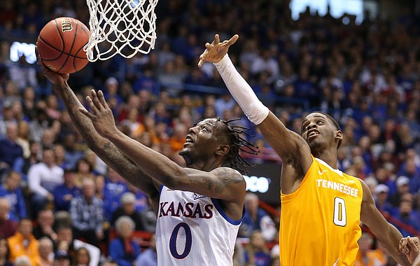 Kansas guard Marcus Garrett (0) floats in for a bucket past Tennessee guard Davonte Gaines (0) during the first half, Saturday, Jan. 25, 2019 at Allen Fieldhouse.