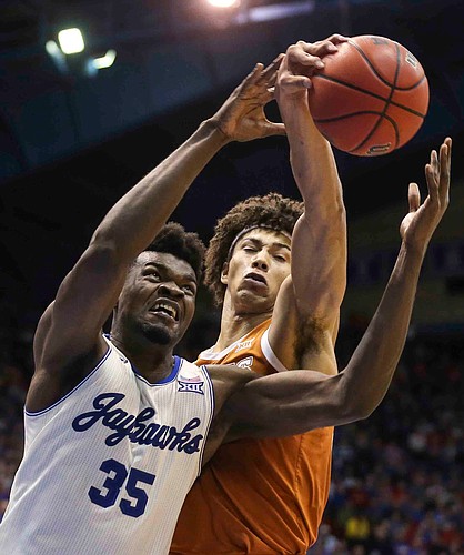 Kansas center Udoka Azubuike (35) battles for a rebound with Texas forward Jericho Sims during the second half on Monday, Feb. 3, 2020 at Allen Fieldhouse.