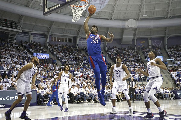 Kansas center Udoka Azubuike (35) dunks against TCU defenders guard Edric Dennis (2), PJ Fuller (4,) Kevin Samuel (21) and Charles O'Bannon Jr. (5) during the first half of an NCAA college basketball game, Saturday, Feb. 8, 2020, in Fort Worth, Texas. (AP Photo/Ron Jenkins)