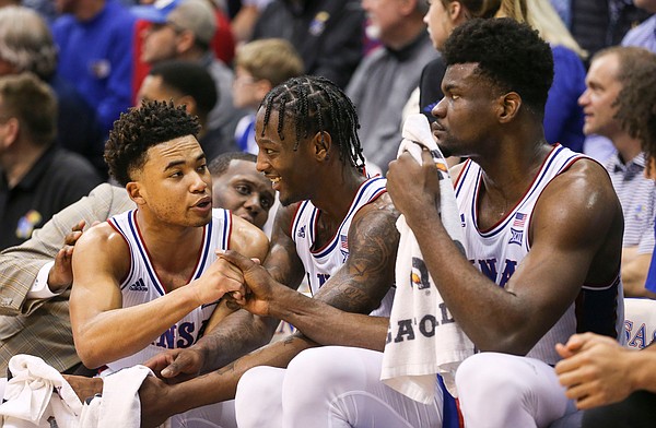 Kansas guards Devon Dotson, left, and Marcus Garrett have a laugh on the bench next to Kansas center Udoka Azubuike (35) with little time remaining in the game on Saturday, Feb. 15, 2020 at Allen Fieldhouse.