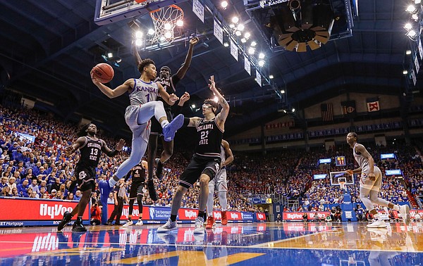 Kansas guard Devon Dotson (1) looks to dish a pass from the baseline during the second half on Monday, Feb. 24, 2020 at Allen Fieldhouse.