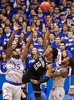 Kansas center Udoka Azubuike (35) and Kansas guard Marcus Garrett (0) contest a shot from Oklahoma State forward Cameron McGriff (12) during the first half on Monday, Feb. 24, 2020 at Allen Fieldhouse.