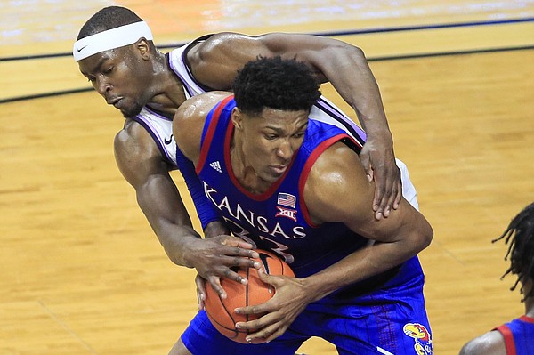 Kansas forward David McCormack (33) is fouled by Kansas State forward Makol Mawien, left, during the second half of an NCAA college basketball game in Manhattan, Kan., Saturday, Feb. 29, 2020. Kansas defeated Kansas State 62-58. (AP Photo/Orlin Wagner)
