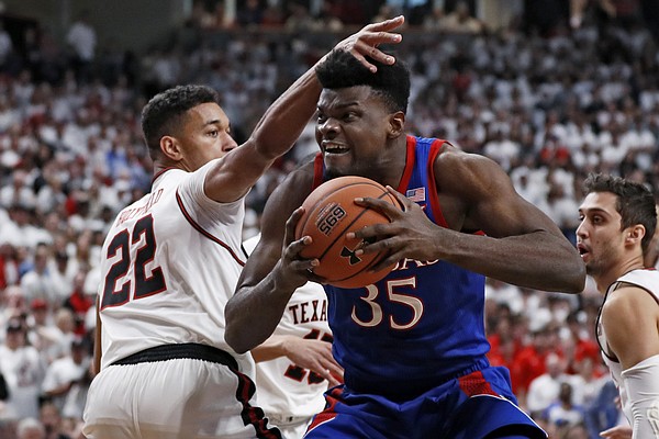Texas Tech's TJ Holyfield (22) defends against Kansas' Udoka Azubuike (35) during the first half of an NCAA college basketball game Saturday, March 7, 2020, in Lubbock, Texas. (AP Photo/Brad Tollefson)
