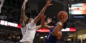 Kansas' Devon Dotson (1) shoots the ball as Texas Tech's Kevin McCullar (15) defends during the second half of an NCAA college basketball game Saturday, March 7, 2020, in Lubbock, Texas. (AP Photo/Brad Tollefson)