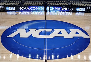 In this March 18, 2015, AP file photo, the NCAA logo is displayed at center court at The Consol Energy Center in Pittsburgh. 