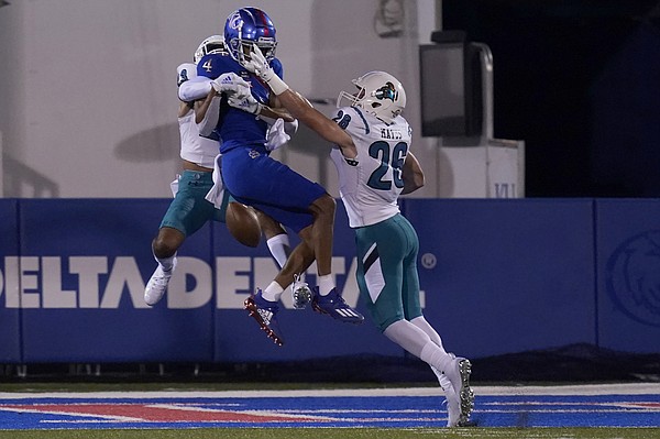 Coastal Carolina cornerback Derick Bush (23) and safety Shi'heem Watkins (28) break up a pass intended for Kansas wide receiver Andrew Parchment (4) during the first half of an NCAA college football game in Lawrence, Kan., Saturday, Sept. 12, 2020. (AP Photo/Orlin Wagner)