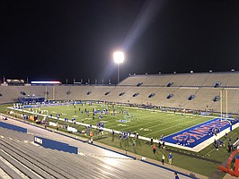 Kansas and Coastal Carolina warm up under the lights on Saturday, Sept. 12, 2020. The game was the season opener for both teams and, with fans not allowed to attend, it featured very few of the normal sights and sounds surrounding David Booth Kansas Memorial Stadium. 