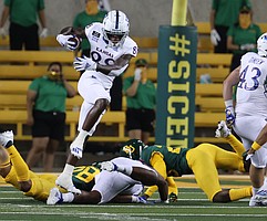 Kansas wide receiver Jamahl Horne (88) jumps over a defender during a kickoff return in the first half of an NCAA college football game, Saturday, Sept. 25, 2020, in Waco, Texas. (Rod Aydelotte/Waco Tribune Herald, via AP)