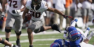 Oklahoma State running back Chuba Hubbard (30) breaks away from Kansas cornerback Johnquai Lewis (11) during the first half of an NCAA college football game in Lawrence, Kan., Saturday, Oct. 3, 2020. 