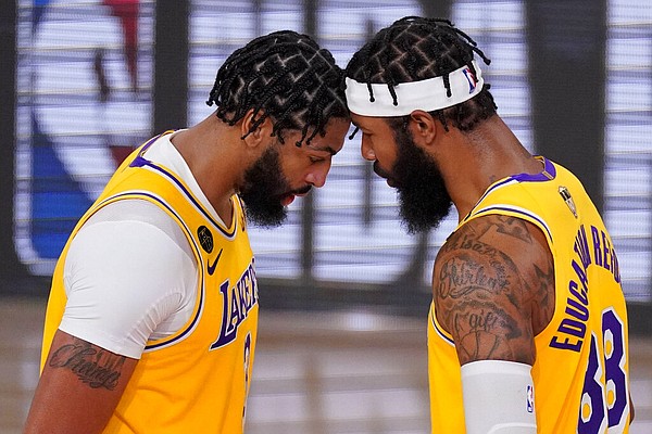 Los Angeles Lakers forward Anthony Davis, left, and forward Markieff Morris react during the second half in Game 4 of basketball's NBA Finals against the Miami Heat on Tuesday, Oct. 6, 2020, in Lake Buena Vista, Fla. (AP Photo/Mark J. Terrill)

