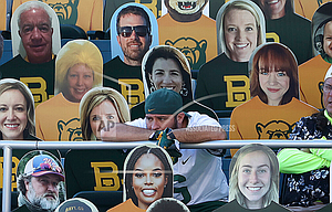 A fan watches an NCAA college football game between TCU and Baylor while seated next to cutouts in Waco, Texas, Saturday, Oct. 31, 2020. (Jerry Larson/Waco Tribune-Herald via AP)


