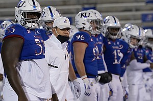 Kansas head coach Les Miles lines up with his team before an NCAA college football game against TCU in Lawrence, Kan., Saturday, Nov. 28, 2020. (AP Photo/Orlin Wagner)