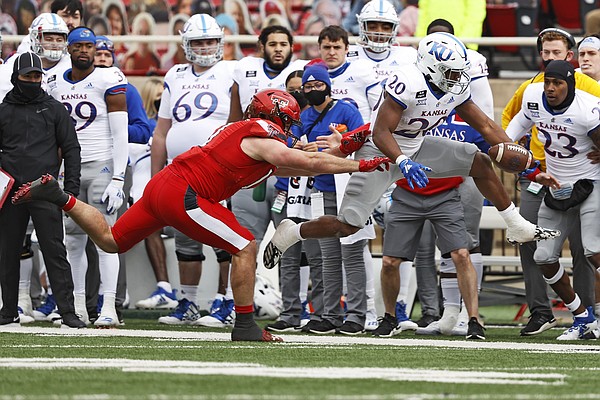 Texas Tech's Colin Schooler (17) pushes Kansas' Daniel Hishaw Jr. (20) out of bounds during the first half of an NCAA college football game Saturday, Dec. 5, 2020, in Lubbock, Texas. (AP Photo/Brad Tollefson)