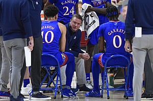 Kansas' head coach Bill Self talks to the team during in a timeout in the first half of an NCAA college basketball game against Texas Tech in Lubbock, Texas, Thursday, Dec. 17, 2020. 

